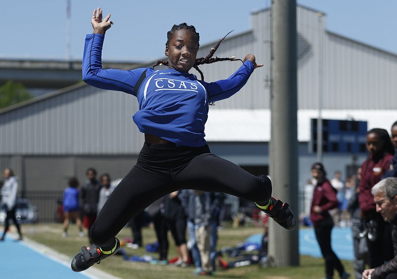 Arts & Sciences' Lennex Walker competes in the long jump at the Optimist track and field meet Saturday at GPS.