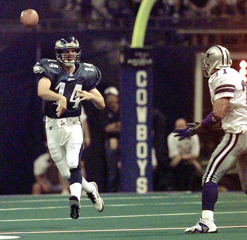 Philadelphia Eagles quarterback Ty Detmer (14) flips a pass away from Dallas Cowboys defender Brock Marion (31) in the second quarter Monday night, Sept. 15, 1997, in Irving, Texas. (AP Photo/Mat Otero)