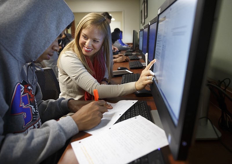 Writing center director Brittney Davidson, center, helps student Thomas Williams with an assignment in the writing center at Chattanooga State Technical Community College on Friday, April 8, 2016, in Chattanooga, Tenn.