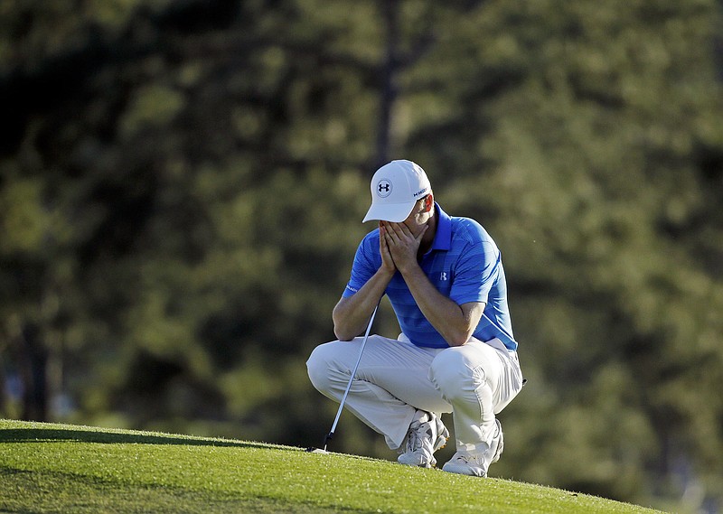 Jordan Spieth pauses on the 18th green before putting out during Sunday's final round of the Masters at Augusta National Golf Club. The 2015 tournament champion led the first three rounds and was on top halfway through the fourth before a bad stretch cost him his second green jacket.