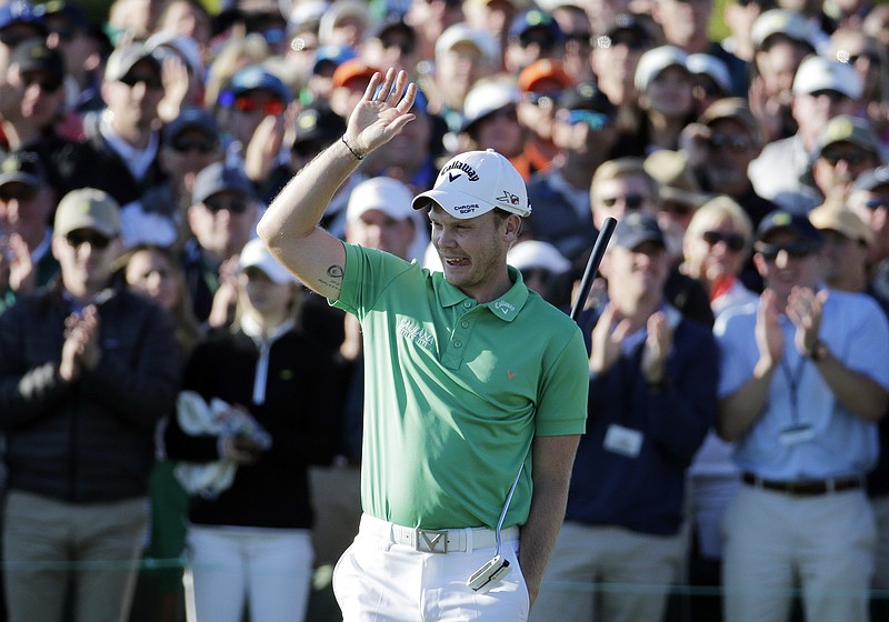 Danny Willett, of England, celebrates on the 18th hole after finishing the final round of the Masters golf tournament Sunday, April 10, 2016, in Augusta, Ga. (AP Photo/Charlie Riedel)