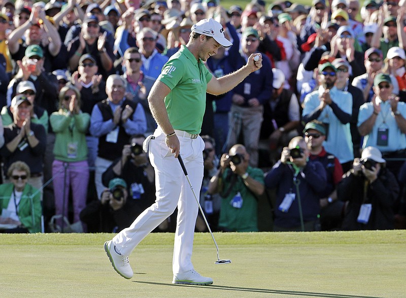 Danny Willett, of England, celebrates on the 18th hole after finishing the final round of the Masters golf tournament Sunday, April 10, 2016, in Augusta, Ga. (AP Photo/Charlie Riedel)
