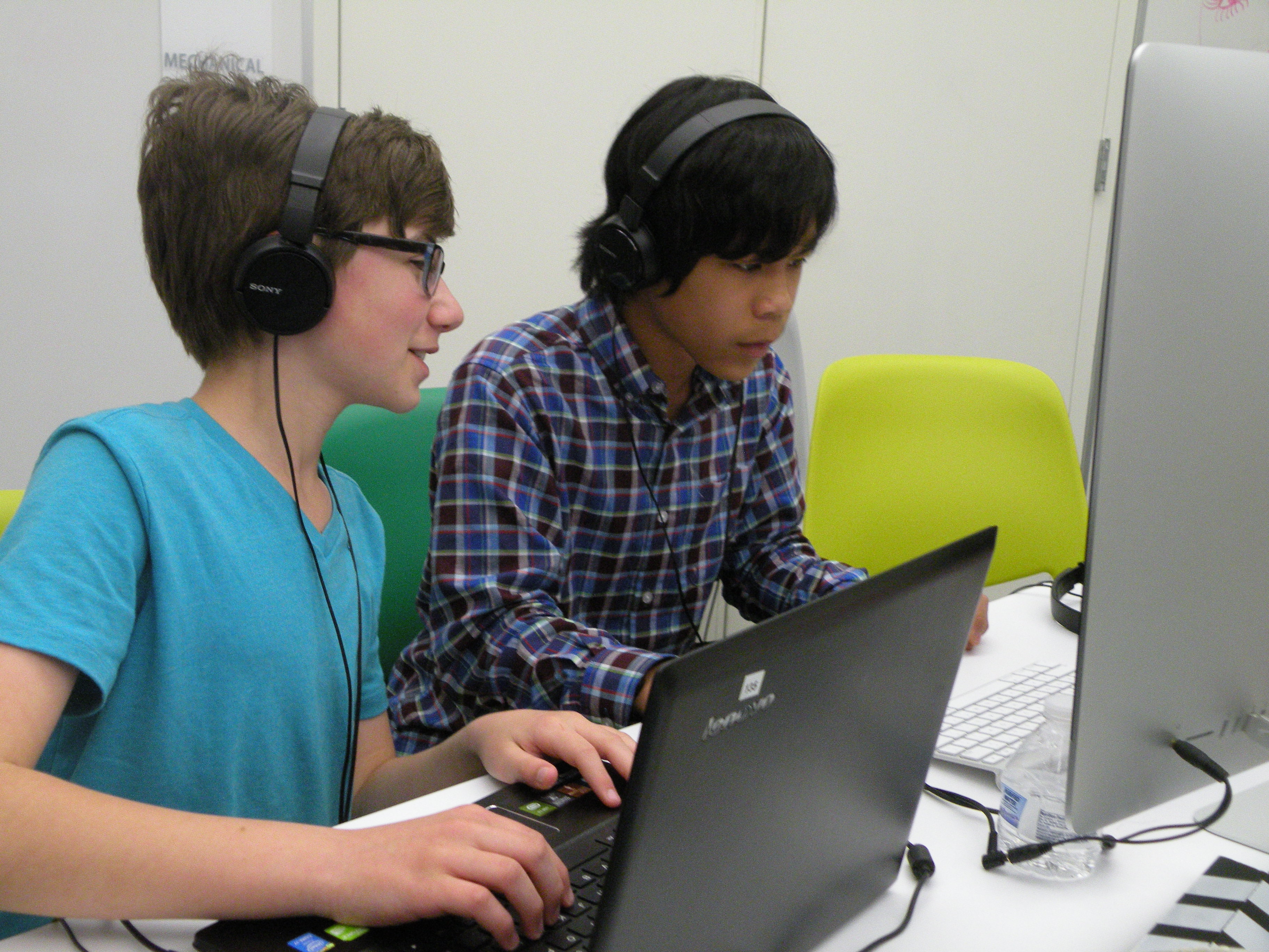 Drew Paddock, left, and Ethan Farnam are deep in concentration as they collaborate on a project.
