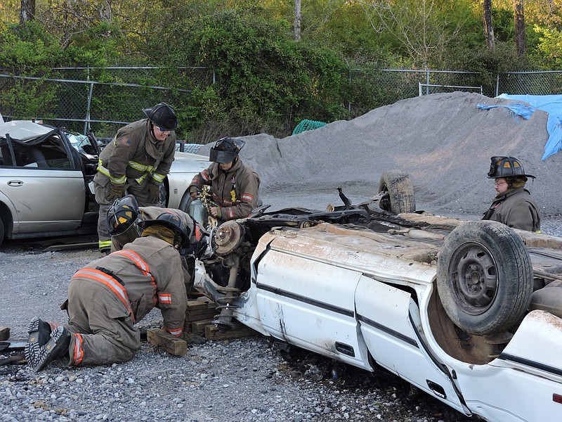 Rossville firefighters work on extrication training on a practice vehicle to raise it up. From left going clockwise are Bo Peardon, Mat Sipsy, Captain Jerry Holder, Courtland Miller, and Keith Broom. Firefighters train 132 hours annually.