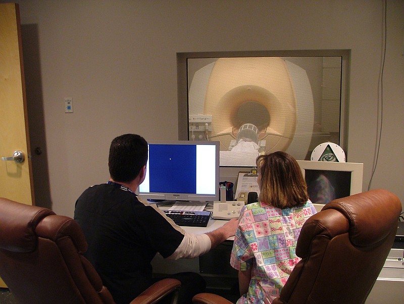 A radiologist and a technician monitor an MRI at Woods Memorial Hospital in Etowah, Tenn.