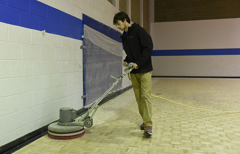 Nick Denise of Praters Athletic Flooring buffs the parquet floor at the Tyner/East Brainerd Recreation Center on Monday, Apr. 11, 2016, in Chattanooga, Tenn. 