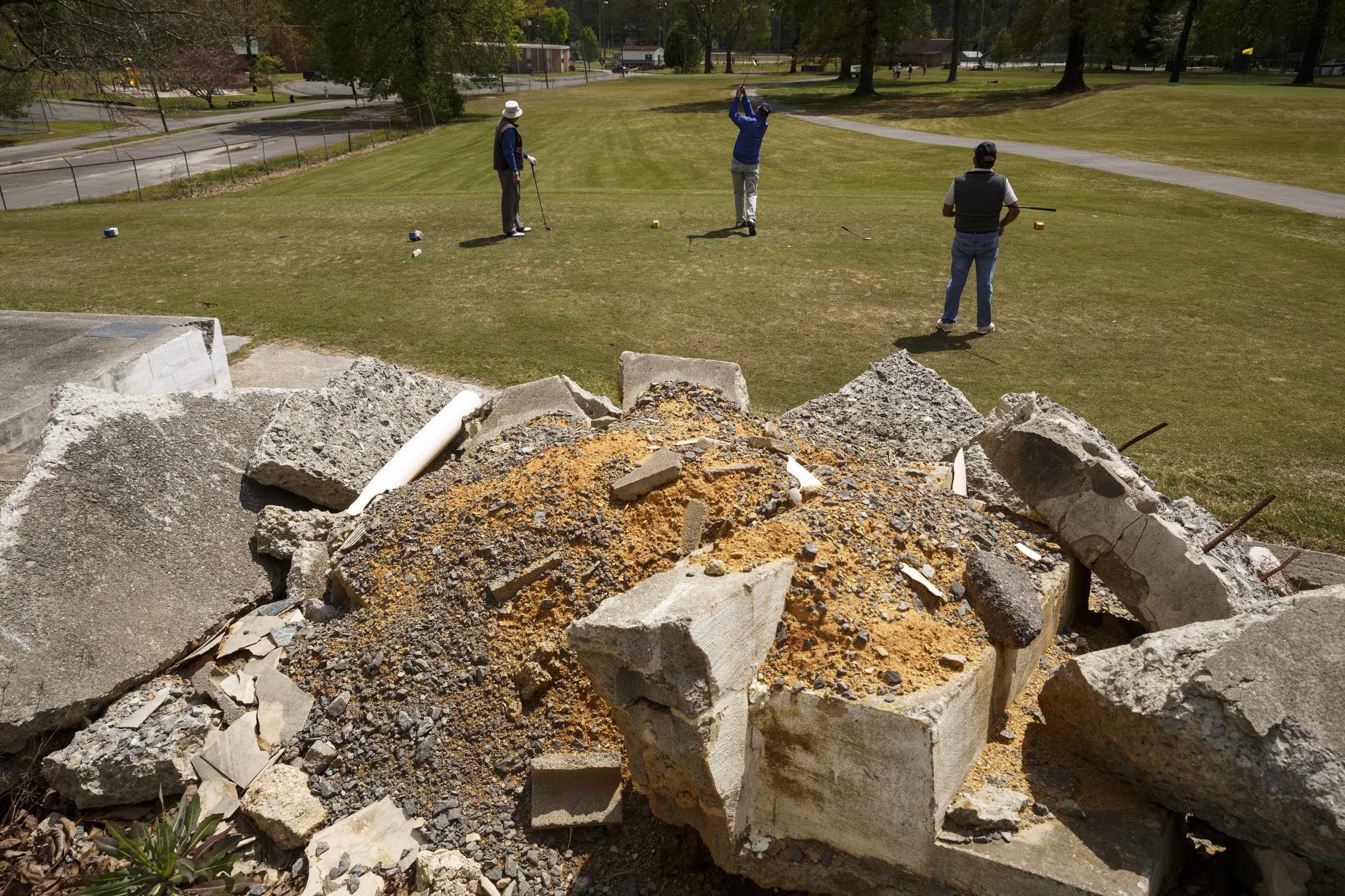 Golfers tee off in front of the remains of the old clubhouse at the LaFayette Municipal Golf Course on Friday, April 8, 2016, in Chattanooga, Tenn. The course has been losing about $150,000 a year since 1998.