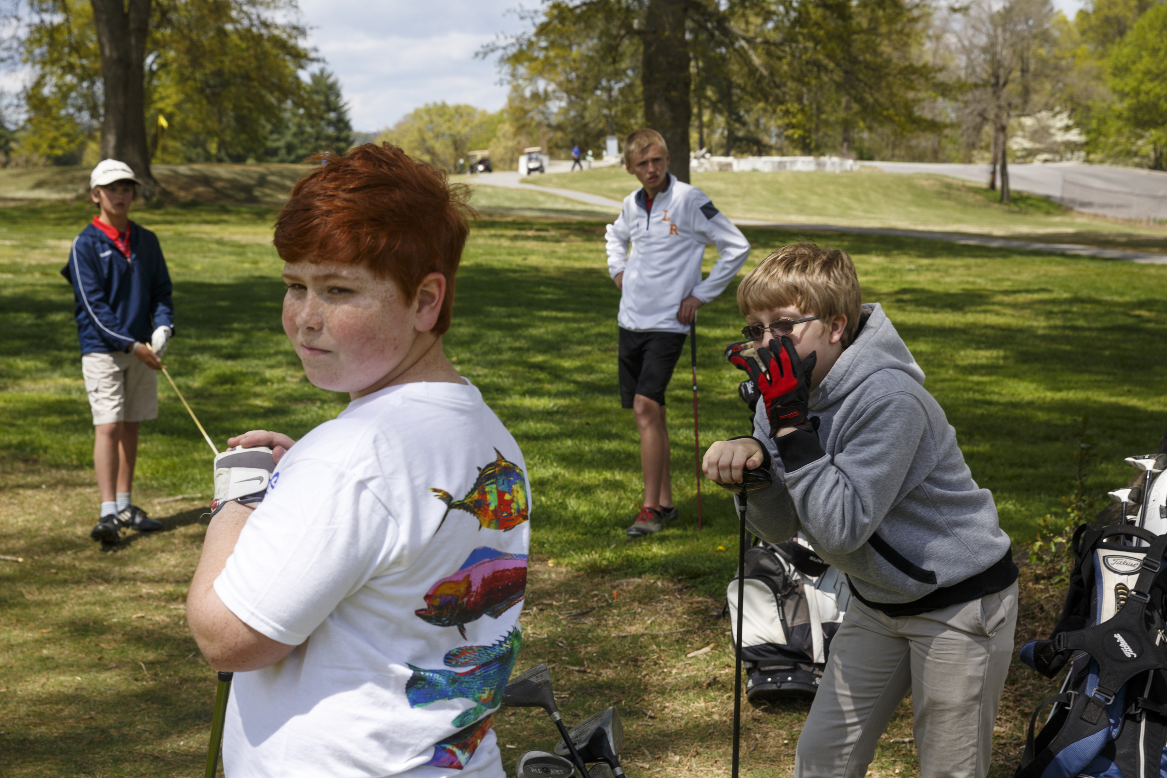 Young golfers Grant Langford, Judson Woods, Tyler Jackson, and Gray Payton, from left, watch as another group plays through at the LaFayette Municipal Golf Course on Friday, April 8, 2016, in Chattanooga, Tenn. The course has been losing about $150,000 a year since 1998, but attracting young golfers could be a boon for the course.