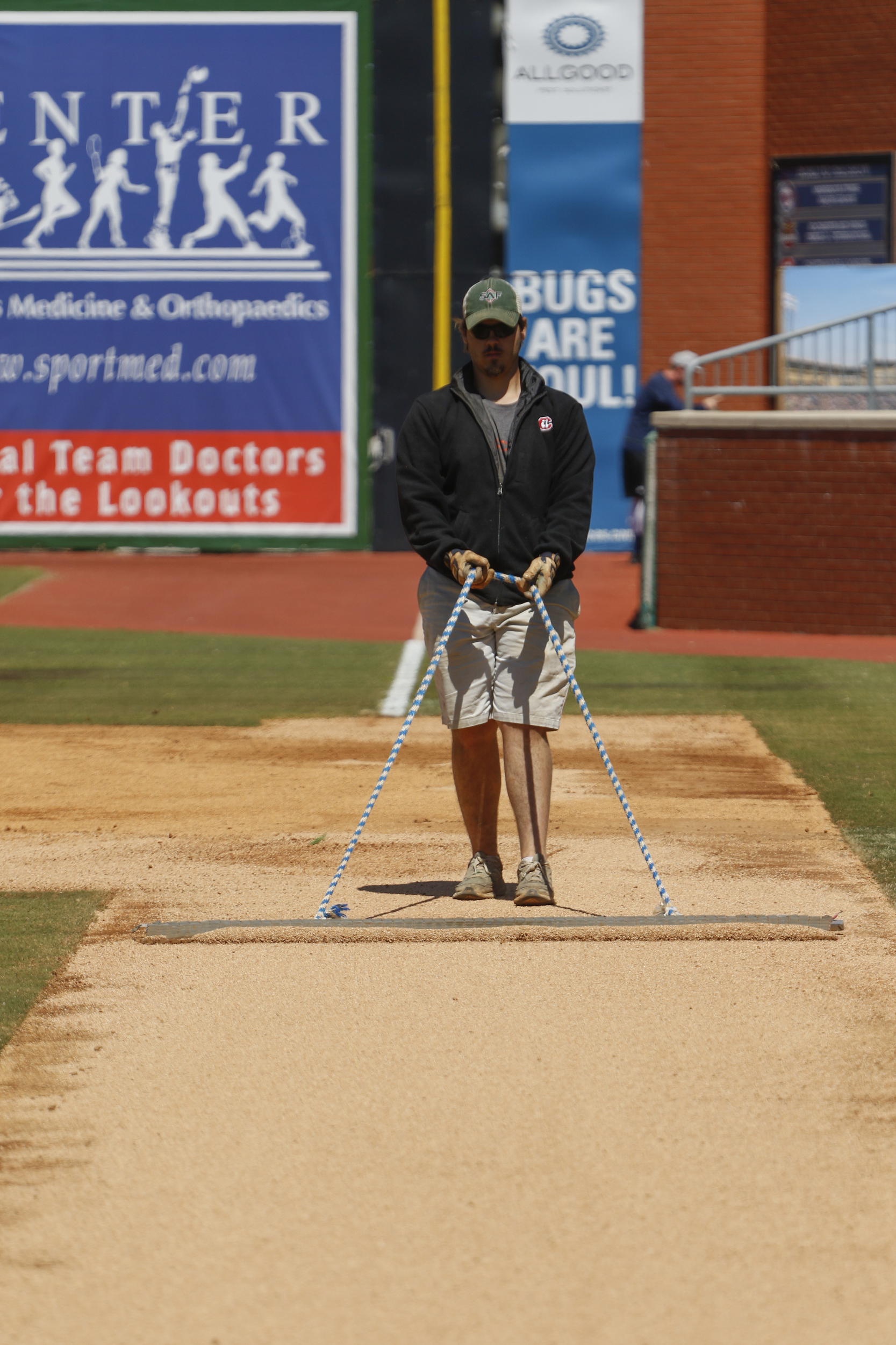 Staff Photo by Dan Henry / The Chattanooga Times Free Press- 4/5/16. Michael Camp drags the first base line in preparation for the Lookouts practice at AT&T field on April 5, 2016.