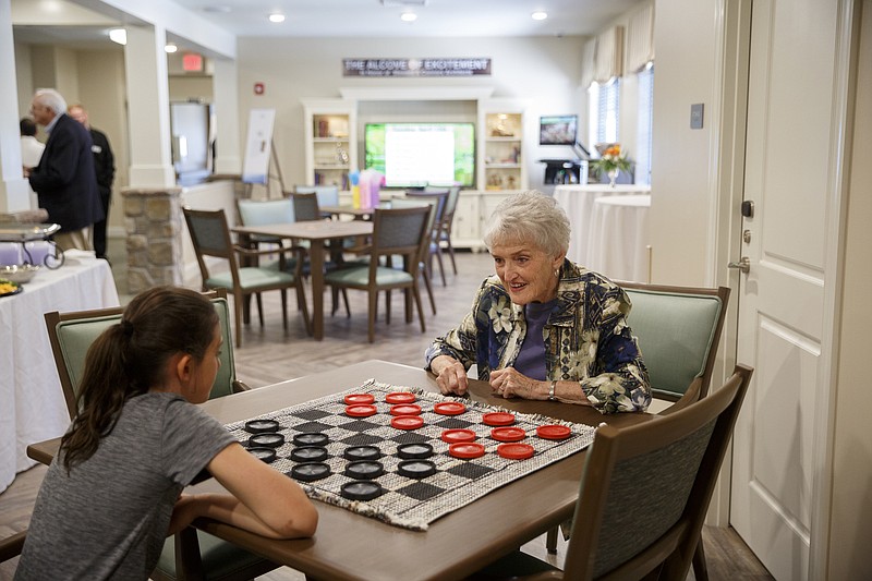 Betty Fox, right, plays checkers with her granddaughter Julia Kaufman at the opening of the Thrive at Brow Wood assisted senior living center Tuesday, April 12, 2016, in Lookout Mountain, Ga.