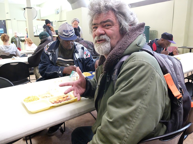 Army Veteran Charles Cloud, 54, talks about being homeless during lunch Tuesday at the Community Kitchen on East Eleventh Street.