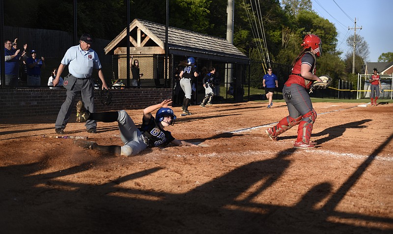 Staff photo by John Rawlston While Baylor catcher Kamrie Rich takes the late throw, GPS pitcher Hannah Kincer slides home with the winning run in the bottom of the eight inning of a girls' high school softball game on Tuesday, Apr. 12, 2016, at the GPS field in Chattanooga, Tenn. GPS won by a score of 2-1.