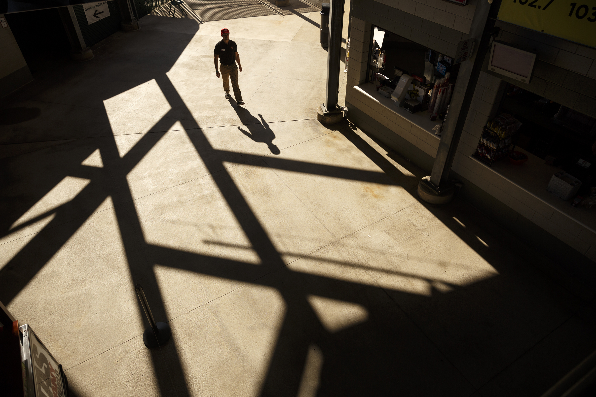 A fan walks past food vendors at the Lookouts' home opener against the Generals at AT&T Field on Tuesday, April 12, 2016, in Chattanooga, Tenn.