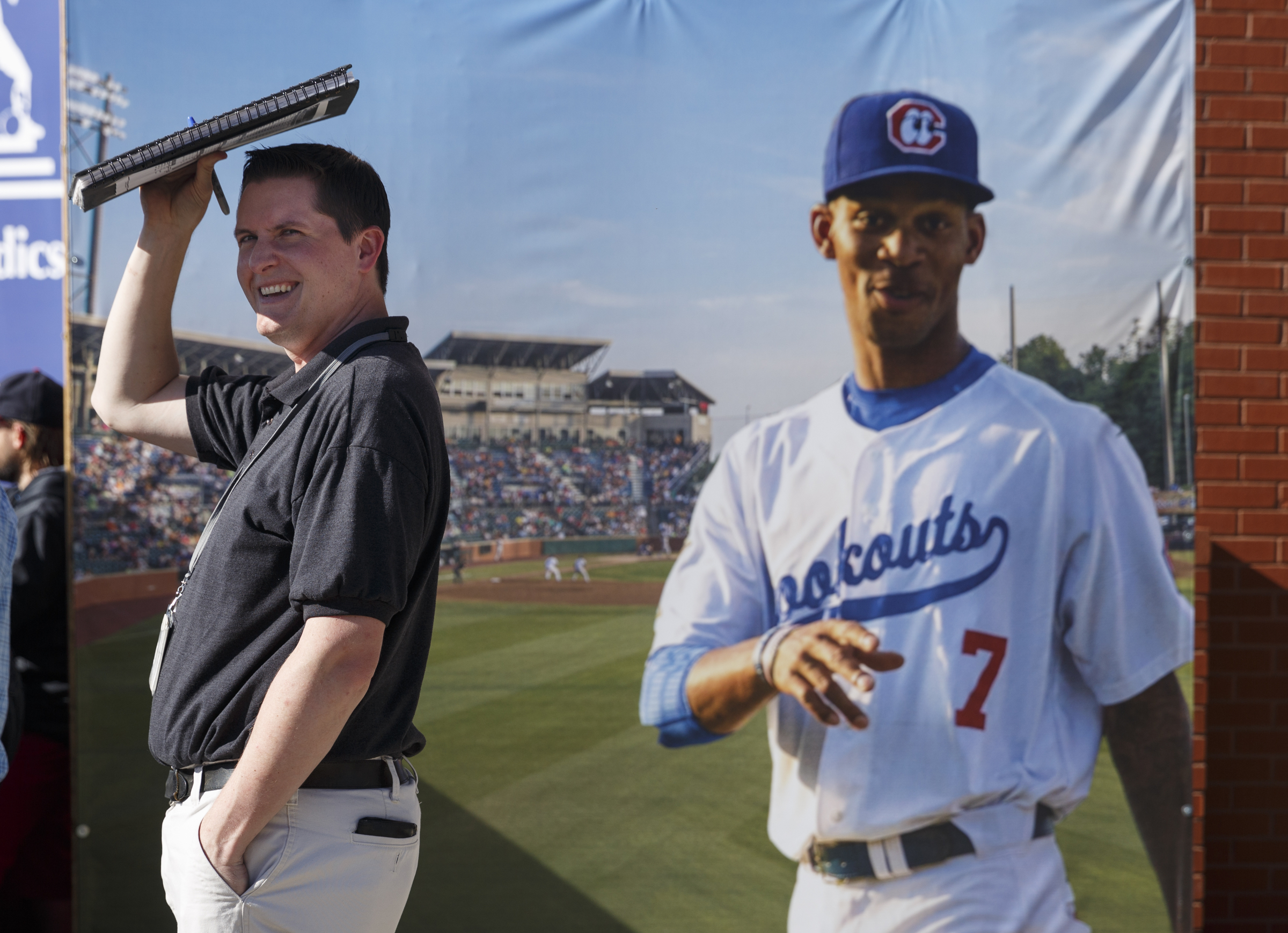 Scott Hensley, left, waits for an autograph next to a poster of a Lookouts player from last season before the Lookouts' home opener against the Generals at AT&T Field on Tuesday, April 12, 2016, in Chattanooga, Tenn.