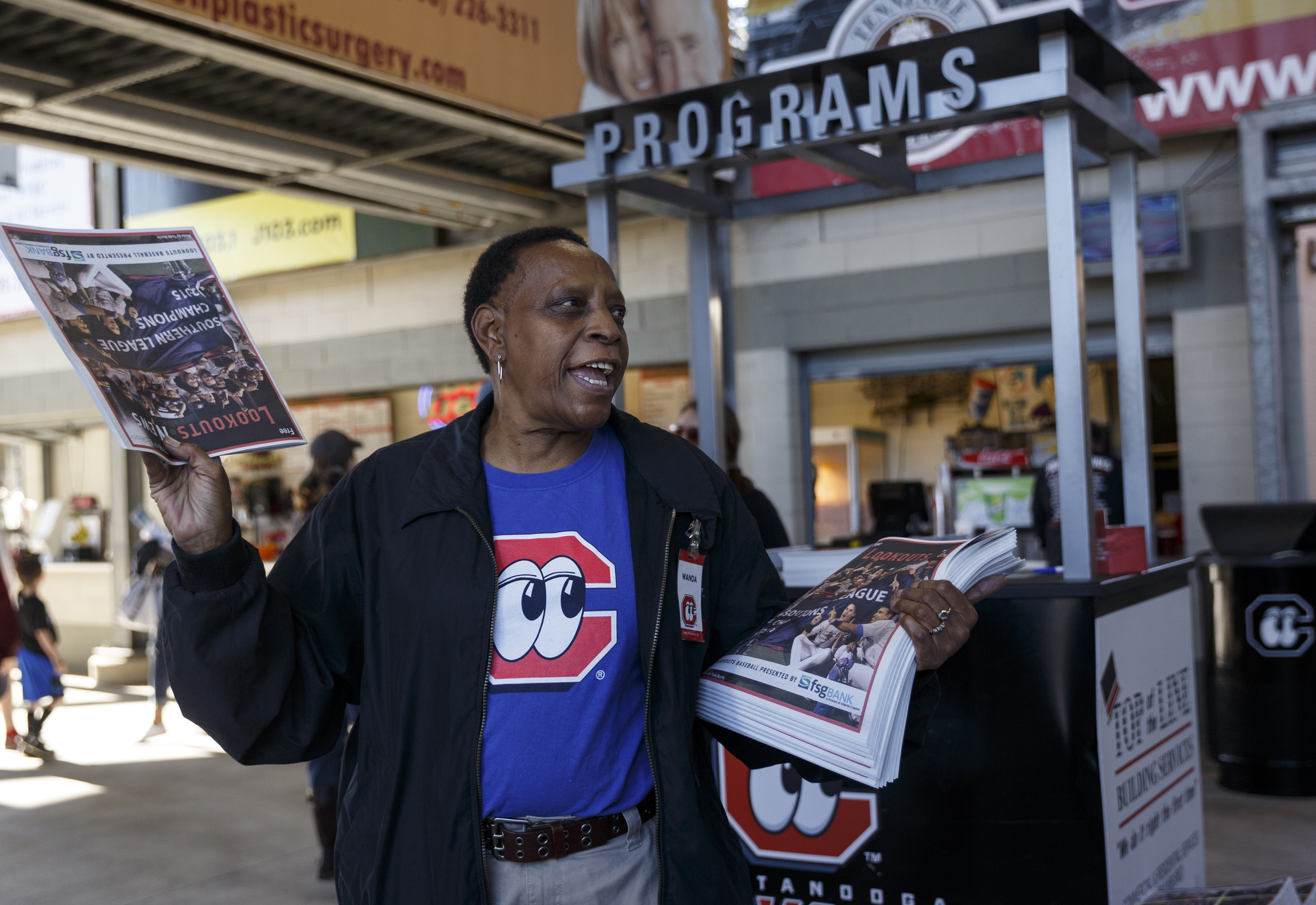 Wanda Goins, who has been with the Lookouts for 26 years, gives away free programs for the Lookouts' home opener against the Generals at AT&T Field on Tuesday, April 12, 2016, in Chattanooga, Tenn.