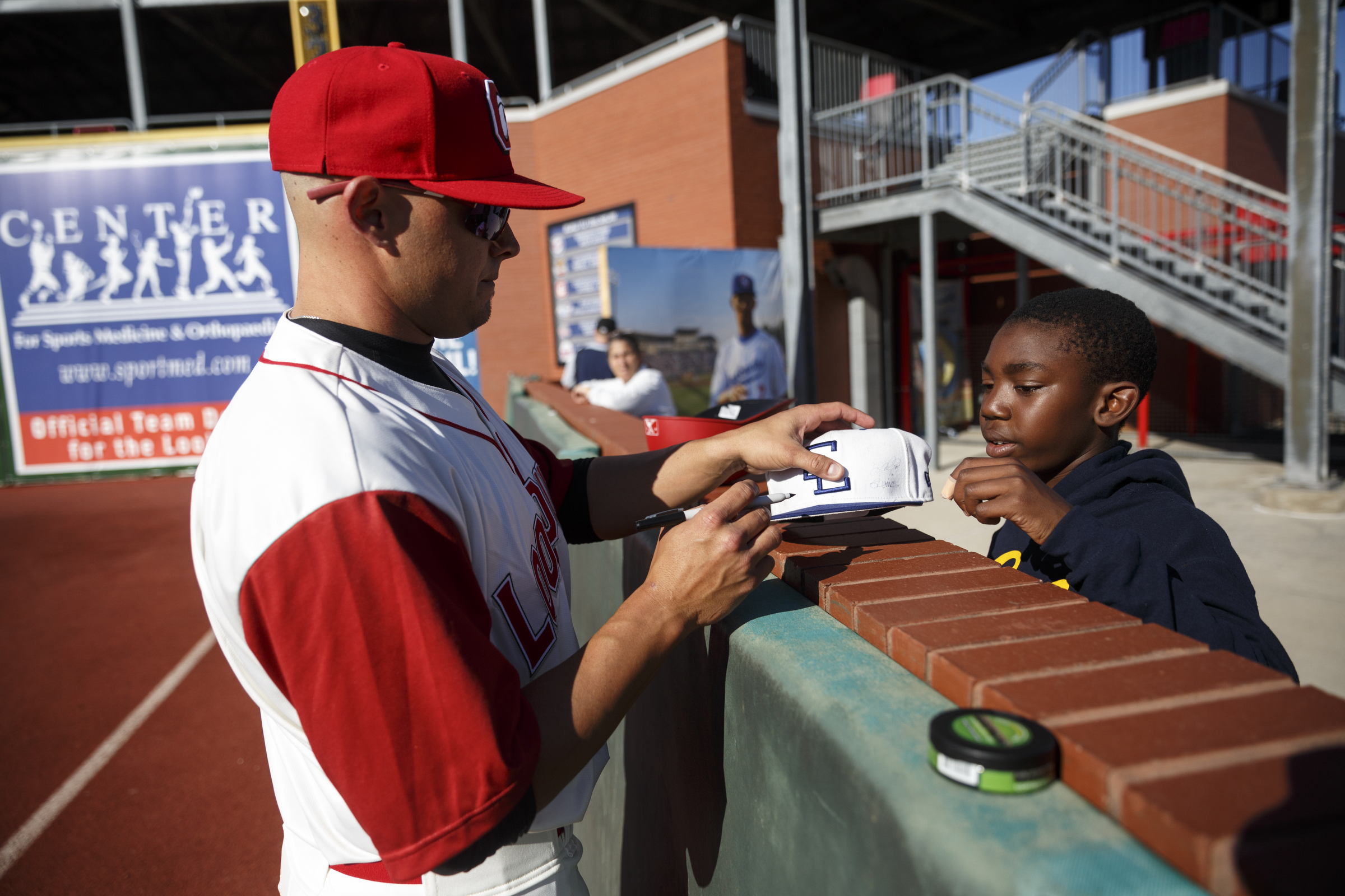 Lookouts player Shannon Wilkerson signs an autograph for Zachary Ubamadu before the Lookouts' home opener against the Generals at AT&T Field on Tuesday, April 12, 2016, in Chattanooga, Tenn.