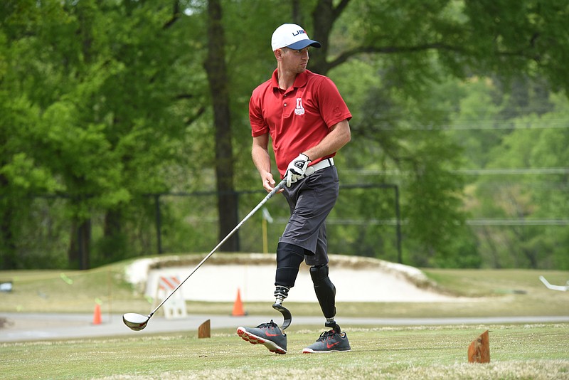 Army Veteran Andrew Smith, 29, looks down No. 1 fairway after teeing off with the UTC golf team on Wednesday at Council Fire. Smith is a 2005 Chattanooga Christian School graduate who majored in History at Lee University, then joined the Army, losing both legs to an IED in Kandahar, Afganistan thereafter.