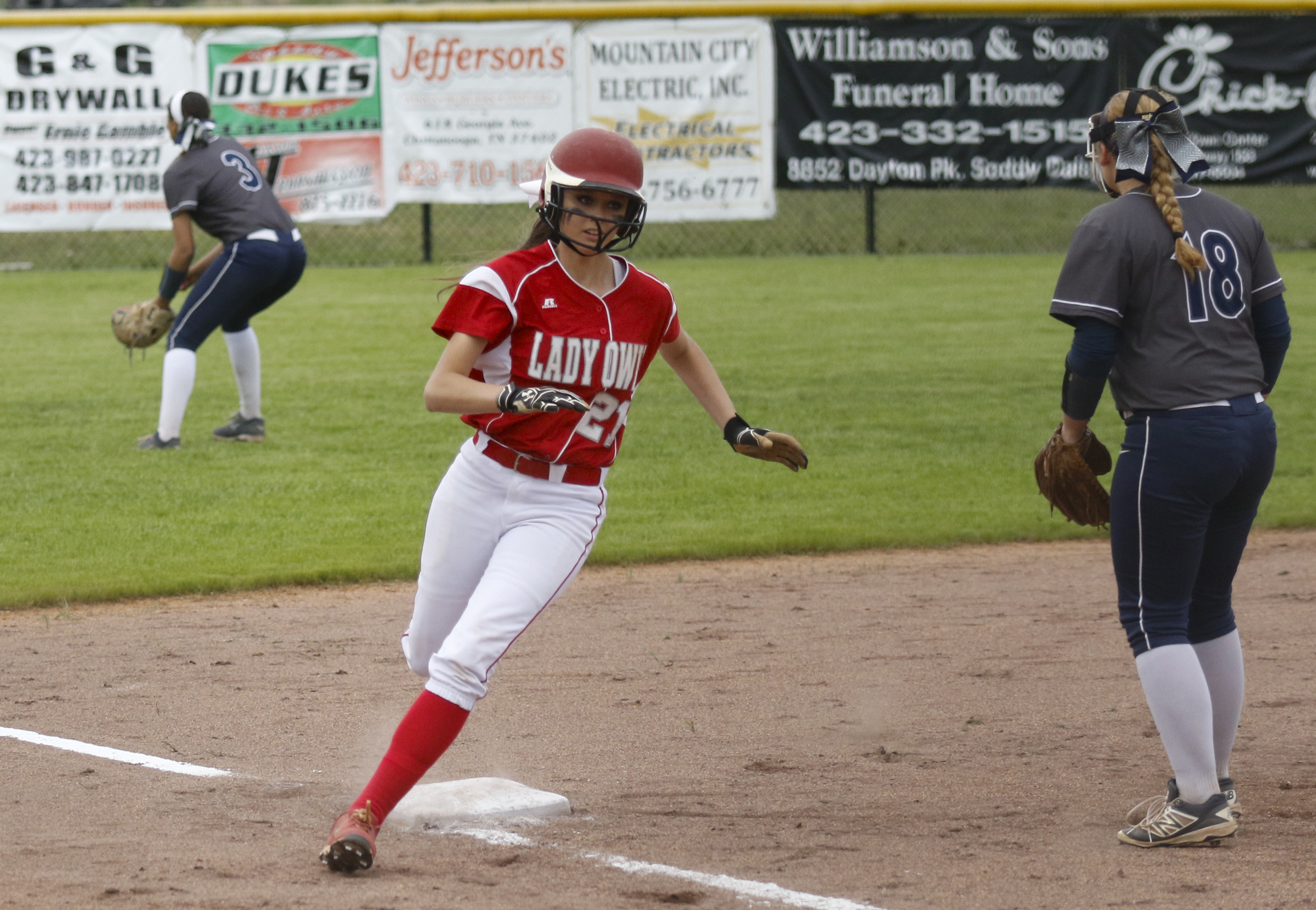 Ooltewah runner Ally Chernak rounds 3rd headed for home as Soddy-Daisy 3rd baseman Grayson Brown waits for the throw-in from the outfield during their softball game at Soddy-Daisy High School on Wednesday, April 13, 2016, in Soddy-Daisy, Tenn.