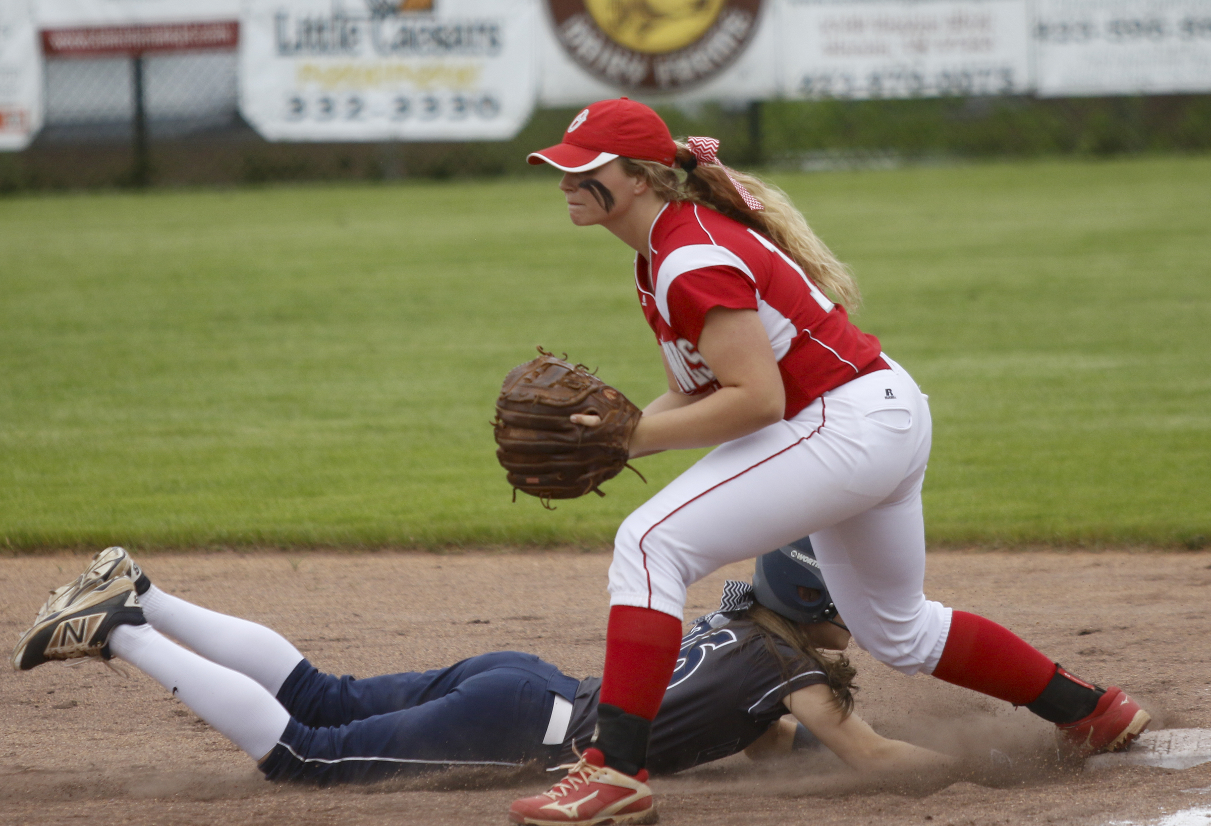 Soddy-Daisy runner _ is forced out at 1st by Ooltewah 1st baseman Aubbie Collake after a fly out during their softball game at Soddy-Daisy High School on Wednesday, April 13, 2016, in Soddy-Daisy, Tenn.