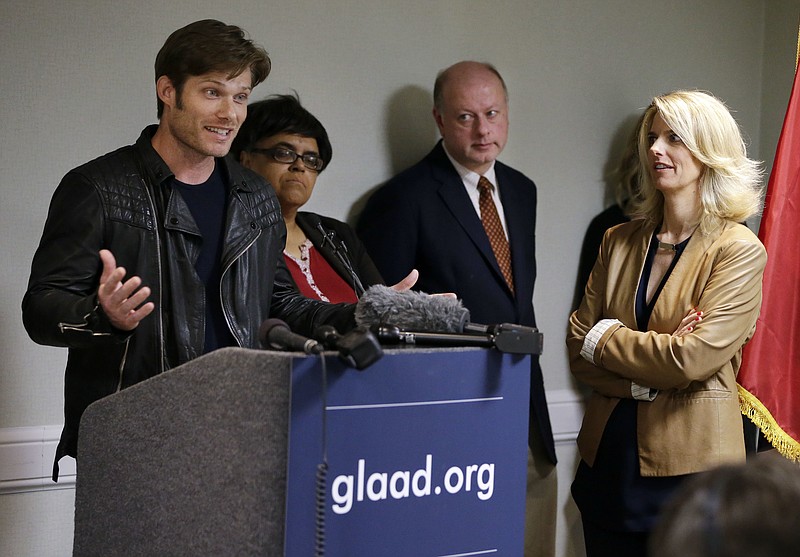 
              In this Monday, April 11, 2016 photo, actor Chris Carmack, from the ABC series "Nashville," left, speaks at a news conference calling on the country music industry to take a stand against proposed laws in Tennessee that LGBT activists see as discriminatory, as Sarah Kate Ellis, left, president and CEO of GLAAD, looks on, in Nashville, Tenn. While a few artists and songwriters have spoken out, many music businesses in Nashville have remained quiet on the issue thus far. (AP Photo/Mark Humphrey)
            