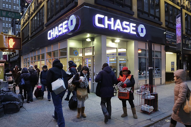 
              FILE - In this Jan. 14, 2015, file photo, people walk past a branch of Chase Bank, in New York. JPMorgan Chase & Co. (JPM) on Wednesday, April 13, 2016, reported first-quarter earnings.  (AP Photo/Mark Lennihan, File)
            