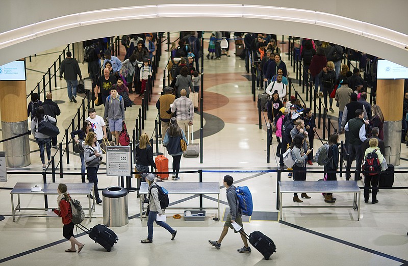 In this Nov. 25, 2015 file photo, travelers wait to go through a security checkpoint at Hartsfield–Jackson Atlanta International Airport in Atlanta.  (AP Photo/David Goldman, File)
            