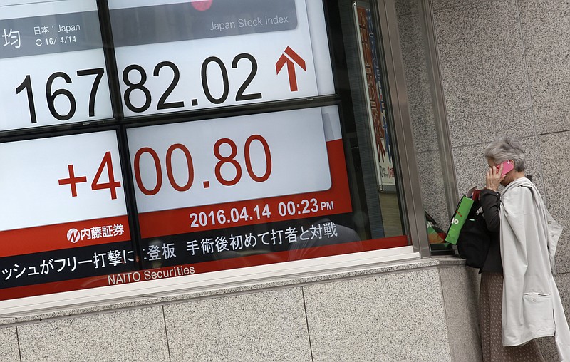 
              A woman talks on a mobile phone near an electronic stock board at a securities firm in Tokyo, Thursday, April 14, 2016. Asian stocks surged in morning trading Thursday in a second day of solid gains, buoyed by a rally on Wall Street and European markets, and an uptick in China's trade. (AP Photo/Eugene Hoshiko)
            