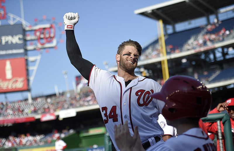 
              Washington Nationals' Bryce Harper pumps his fist as he takes a curtain call after he hit a grand slam during the third  inning of an baseball game against the Atlanta Braves, Thursday, April 14, 2016, in Washington. This was Harper's 100th home run of his career. (AP Photo/Nick Wass)
            