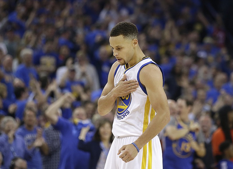 
              Golden State Warriors guard Stephen Curry reacts after making a three point basket during the first half of an NBA basketball game against the Memphis Grizzlies in Oakland, Calif., Wednesday, April 13, 2016. (AP Photo/Marcio Jose Sanchez)
            