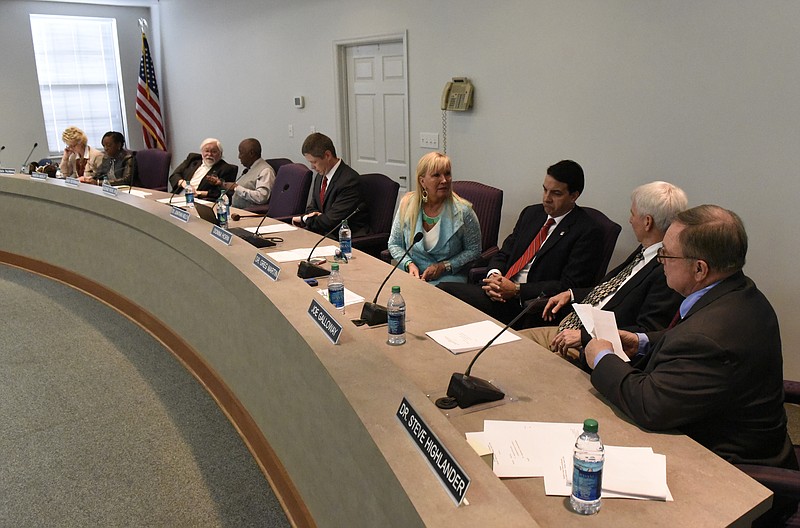 Members of the Hamilton County School Board chat prior to the start of a meeting.