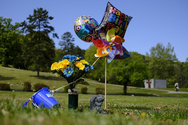 Birthday balloons, flowers, and a pinwheel decorate the grave site of Demarcus Bryant, who died in March 2014 from an overdose caused by a 25-microgram fentanyl patch, at Greenwood Cemetery on Friday, April 15, 2016, in Chattanooga, Tenn. Bryant would have celebrated his 4th birthday on April 12th. Last week, a jury convicted Bryant's caretaker, Jaqueline Escareno, 52, of criminally negligent homicide for Bryant's death.