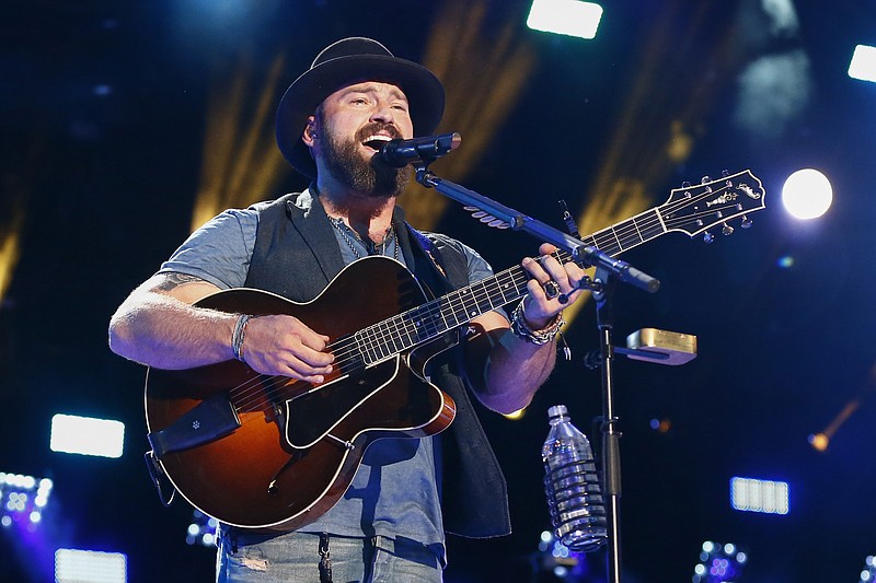 
              FILE - In this June 12, 2015 file photo, Zac Brown of the Zac Brown Band performs at LP Field at the CMA Music Festival in Nashville, Tenn. Brown said in a statement that he was in the wrong place at the wrong time at a Palm Beach hotel in which four people were arrested for drug possession. A report from Palm Beach Police Department showed that Brown was present when police arrived at the Four Seasons Hotel on April 8, but he was not charged or arrested.  (Photo by Al Wagner/Invision/AP, File)
            