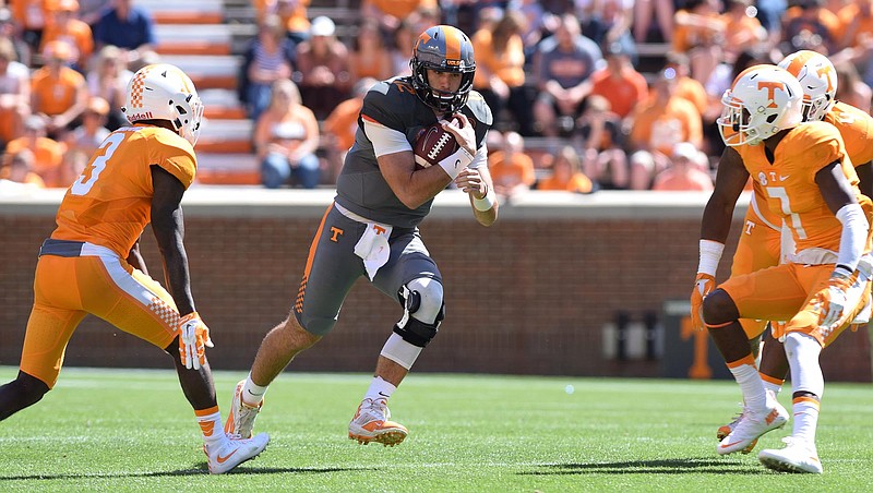Quarterback Quinten Dormady (12) rushes between Marquill Osborne (3) and Rashaan Gaulden (7).  The University of Tennessee Orange/White Spring Football Game was held at Neyland Stadium in Knoxville on April 16, 2016.