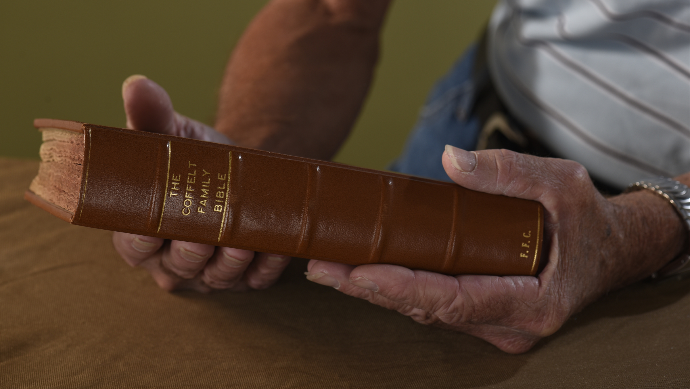 Carly Wilkey is photographed on Tuesday, Nov. 3, 2015, in Chattanooga, Tenn., holding the Bible given to his grandfather, Fletcher Coffelt, by his grandmother, Olie Mae (Warf) Coffelt, in 1924. The deteriorated cover of the old Bible was replaced several years ago.