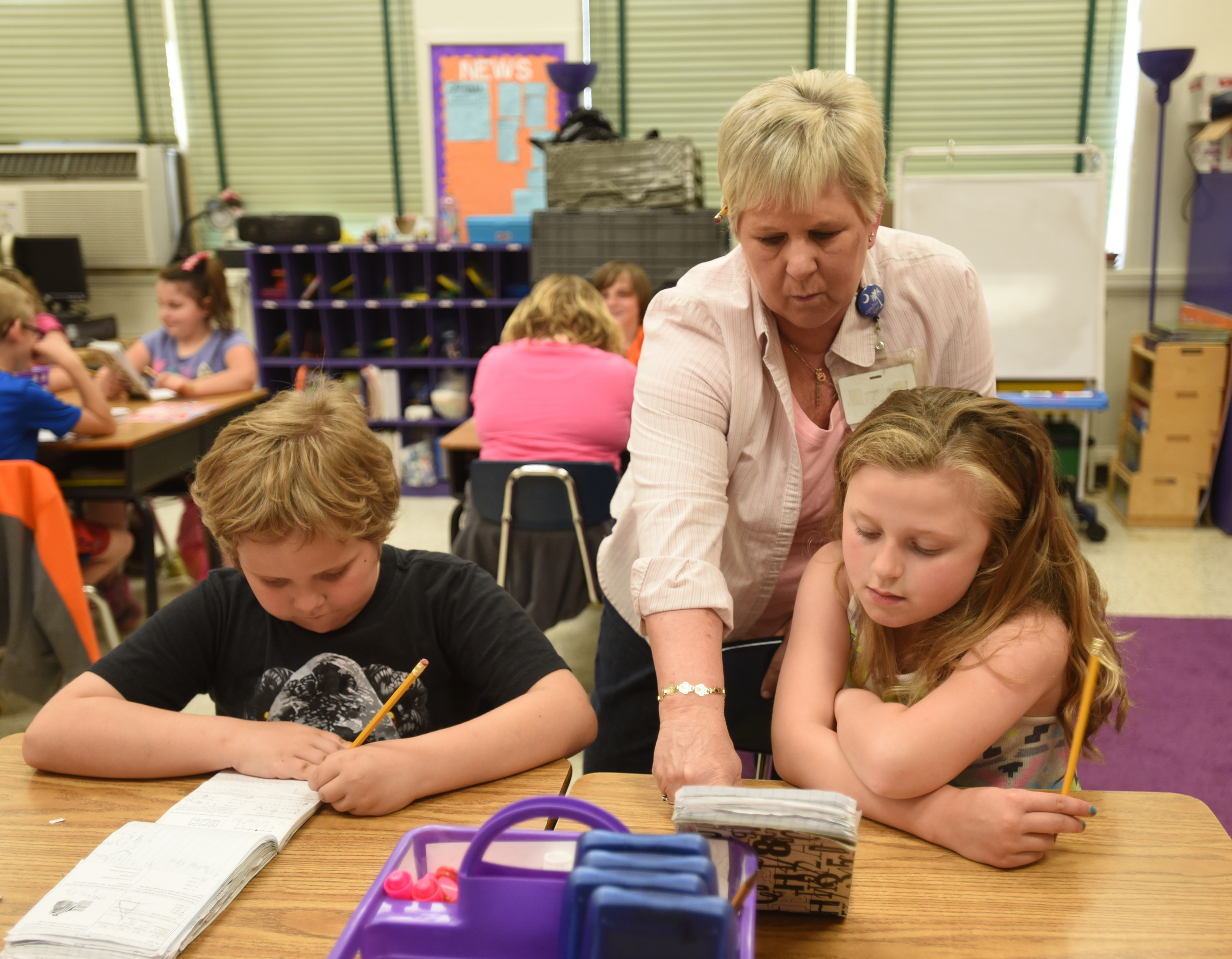 Nelle Ward works with Ainsley Jordan, right, and Adam Smart Wednesday, April 13, 2016 at Falling Water Elementary School.
