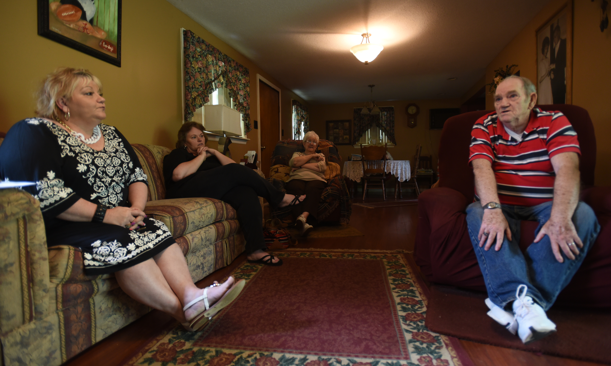 Jeannine Hart, Karan Johnson and Imogene Selcer, from left, listen as George Selcer tells stories Wednesday, April 13, 2016 of attending Falling Water Elementary School.
