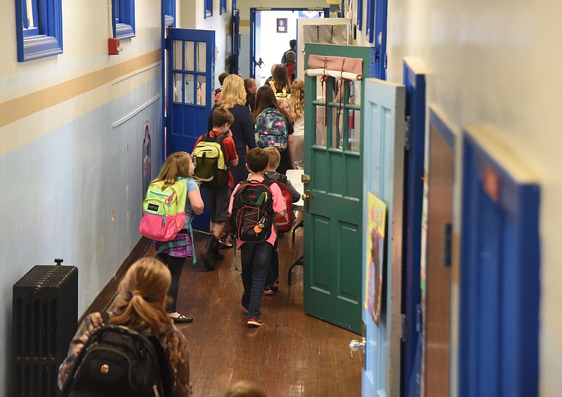 Students walk down the hallway Wednesday, April 13, 2016 at Falling Water Elementary School.