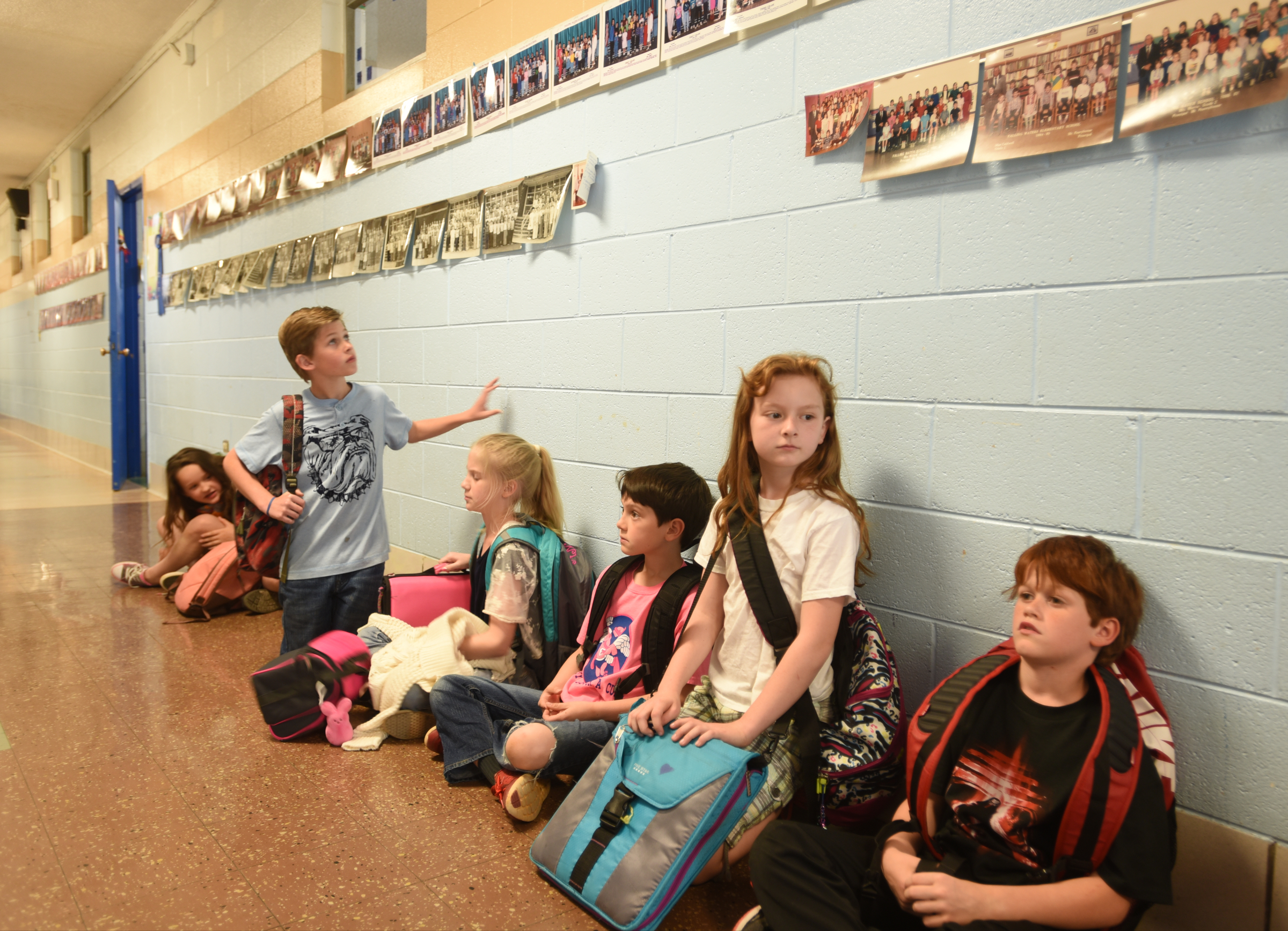 Kids line the hallway as they wait to be picked up Wednesday, April 13, 2016 at Falling Water Elementary School.