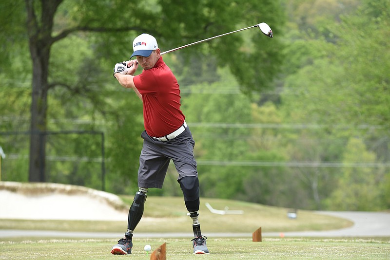 
              ADVANCE FOR WEEKEND EDITIONS APRIL 16-17 -Andrew Smith, tees off with the rest of the UTC golf team Wednesday, April 13, 2016 at Council Fire in Chattanooga, Tenn. 29-year-old Andrew Smith, life changed March 8, 2012, the day he stepped on an improvised explosive device outside Kandahar, Afghanistan. He was just 18 days into his tour of duty with the 82nd Airborne Division out of Fort Bragg, N.C., and less than three months removed from his and Tori's wedding. (Tim Barber/Chattanooga Times Free Press via AP) THE DAILY CITIZEN OUT; NOOGA.COM OUT; CLEVELAND DAILY BANNER OUT; LOCAL INTERNET OUT; MANDATORY CREDIT
            