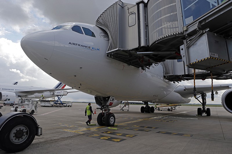
              Air France ground staffs work next to the Airbus A330 of the AF 738 Paris Teheran inaugural flight at Roissy Charles De Gaulle Airport, north of Paris, France, Sunday, April 17, 2016. Air France resumes flights to Iran after last year's landmark deal to curb Iranian nuclear activities, as part of larger French and European efforts to rebuild trade ties long frozen by sanctions. (AP Photo/Francois Mori)
            