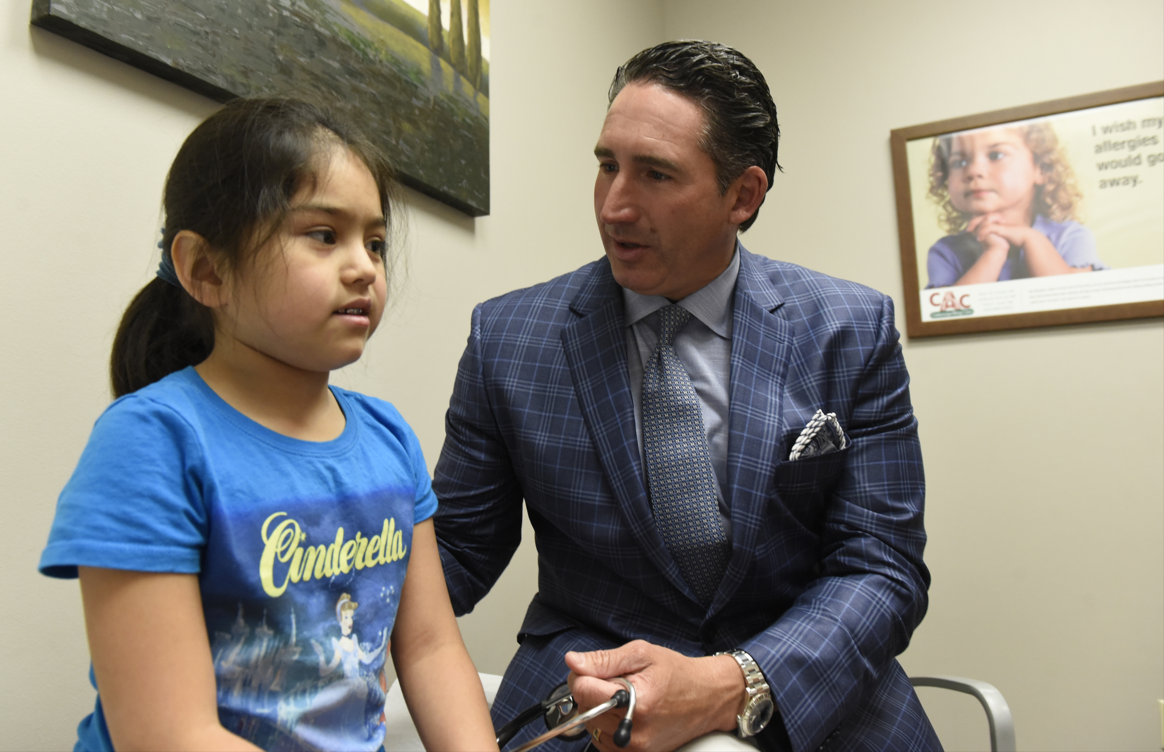 Dr. Mark Cromie talks with patient Paulina Gomez, 7, in his offices at the Chattanooga Allergy Clinic.