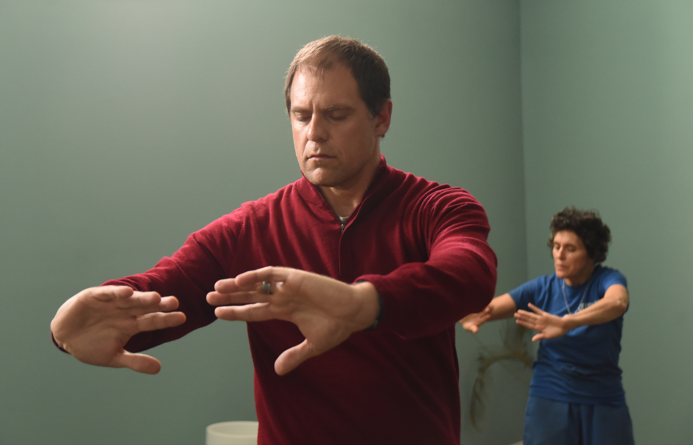 Chad Dupuis, left, leads qigong exercises as Joan Marie Worsham follows at Yin Yang House Acupuncture and Wellness Center. Such exercises are said to help relieve allergy symptoms.