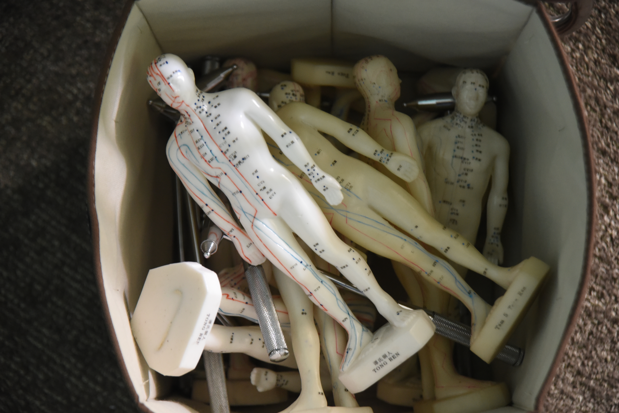 At Yin Yang House Acupuncture and Wellness Center, Chad Dupuis uses acupuncture dolls to help patients understand where the needles are going to be placed for allergy relief.