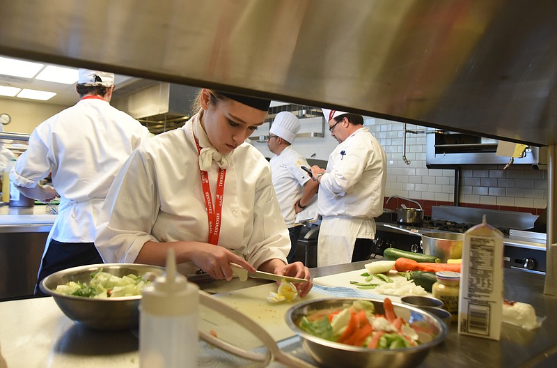 Ooltewah High School student Daisa Huff puts together a salad Monday, April 18, 2016 during the SkillsUSA State Culinary Competition at Virginia College.