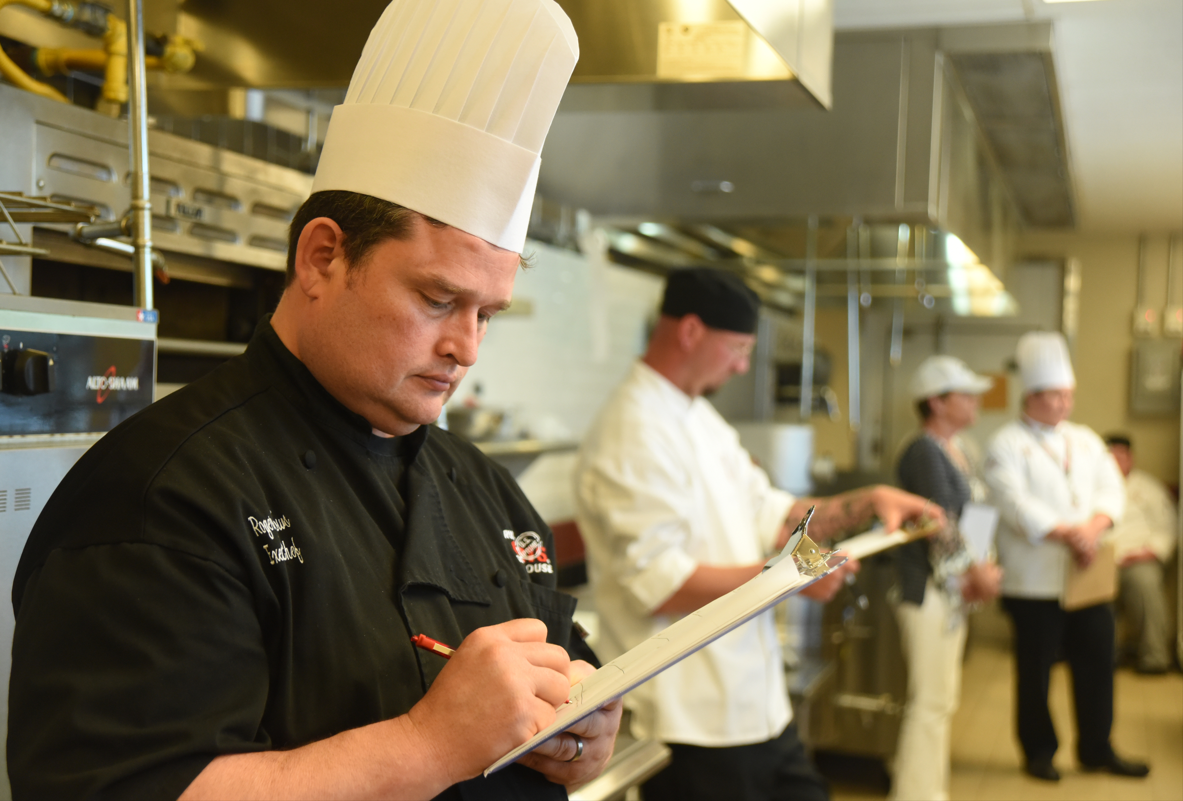 Executive Chef Roger Burrows from Ruth's Chris Steak House, takes notes Monday, April 18, 2016 while judging the SkillsUSA State Culinary Competition at Virginia College.