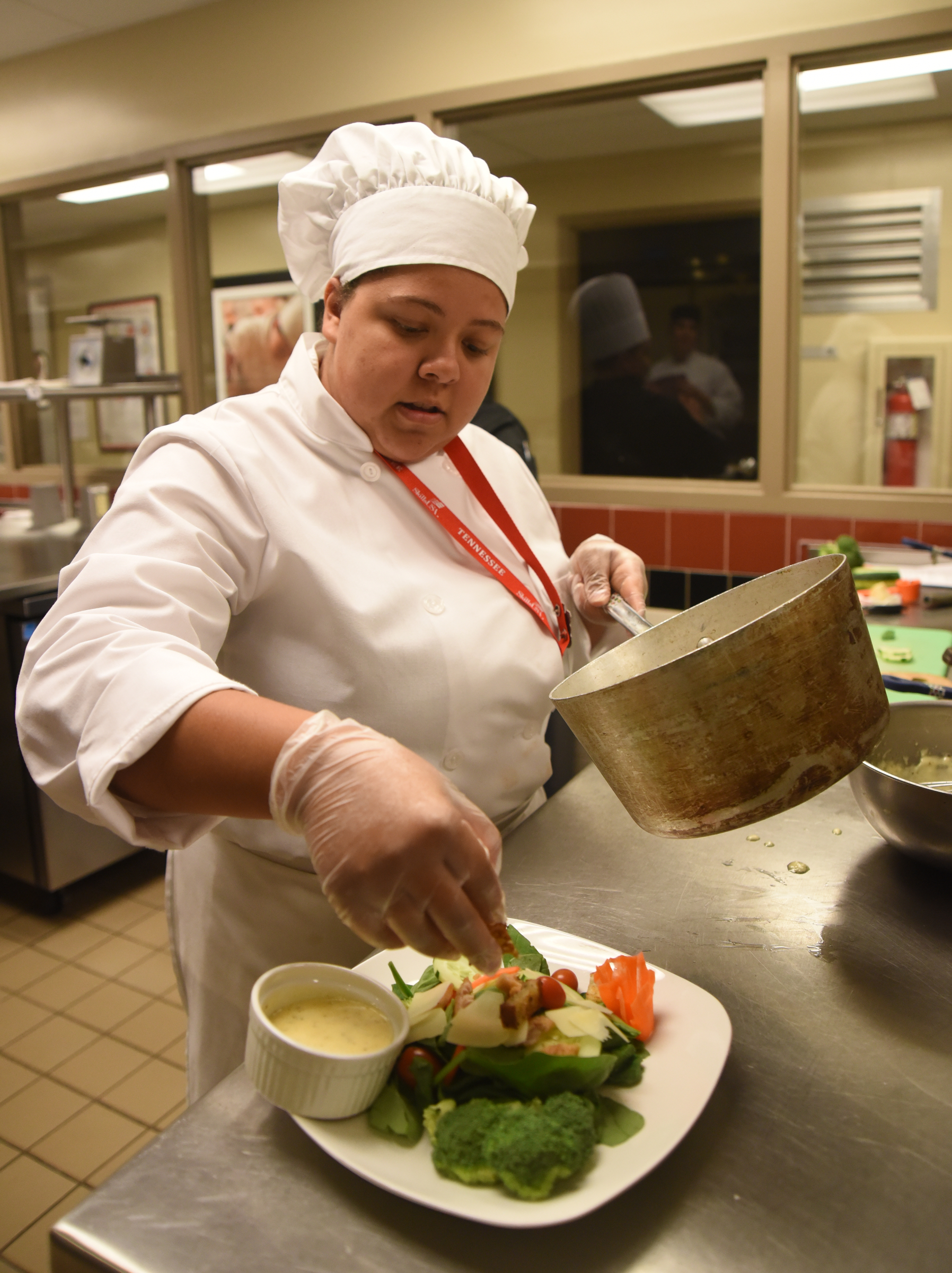 Dobyns-Bennett High School student Kyonna Salyer puts finishing touches on a salad Monday, April 18, 2016 during the SkillsUSA State Culinary Competition at Virginia College.