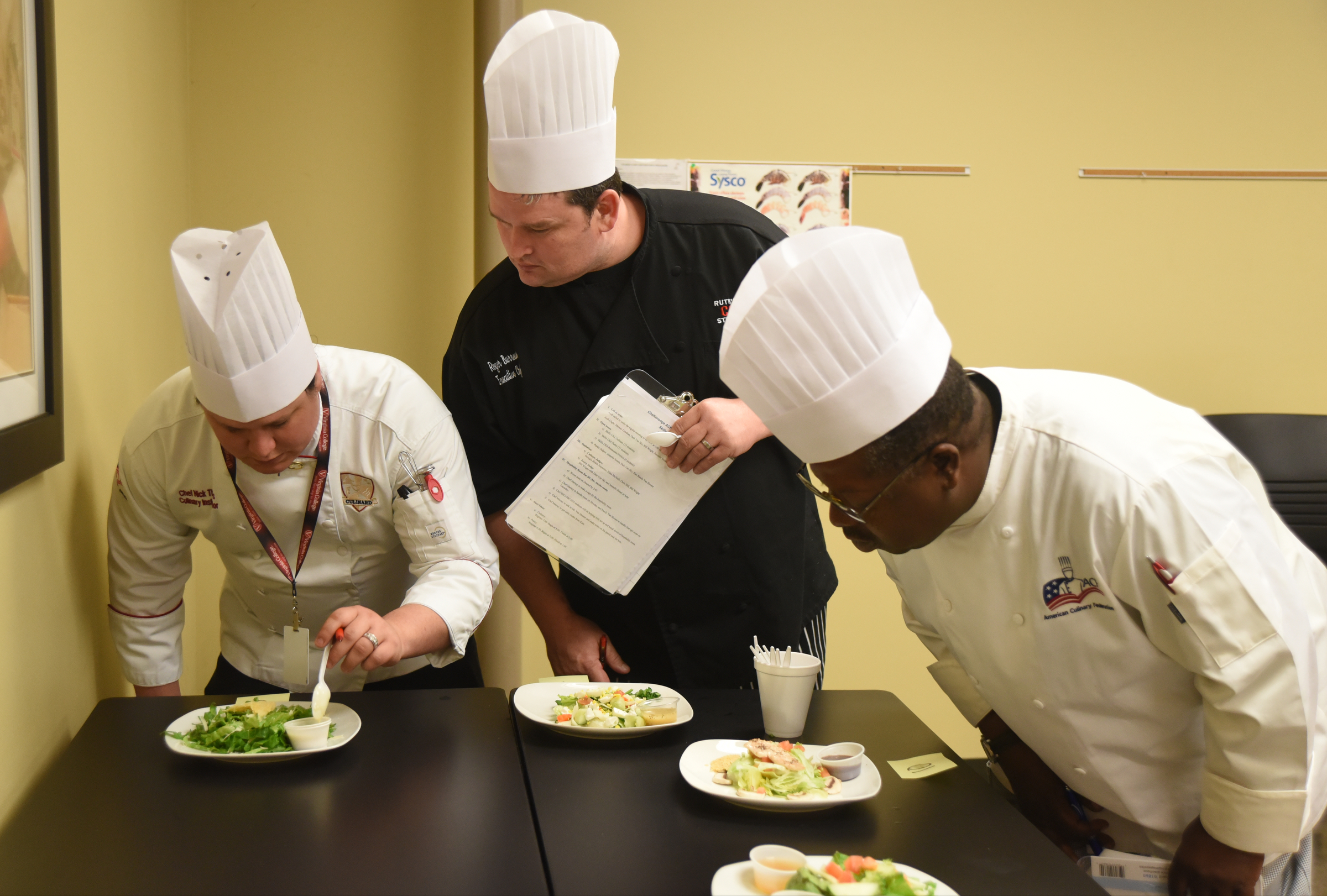Chefs Nick Theirs, Roger Burrows and Aaron Oliver, from left, judge salads Monday, April 18, 2016 during the SkillsUSA State Culinary Competition at Virginia College.