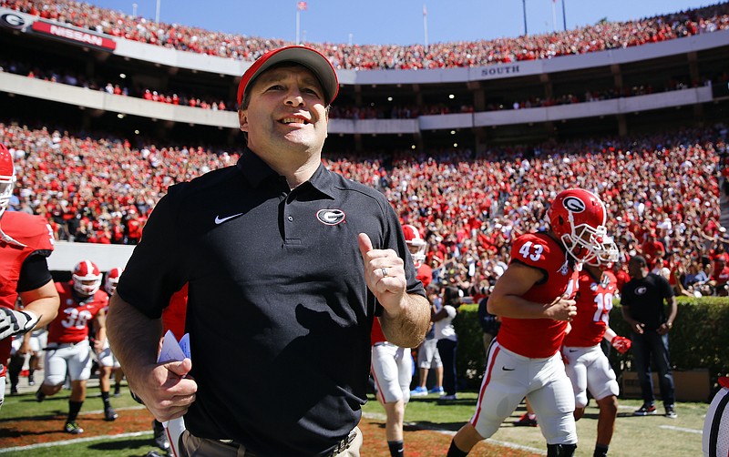 FILE - In this April 16, 2016 file photo, Georgia first-year head coach Kirby Smart runs into a packed Sandford Stadium with his players for the school's spring NCAA college football game in Athens, Ga. The Southeastern Conference Eastern Divisions new look added more intrigue than usual to spring practice. Three of the divisions seven teams - Georgia, Missouri and South Carolina - are breaking in new head coaches. (AP Photo/John Bazemore, File)