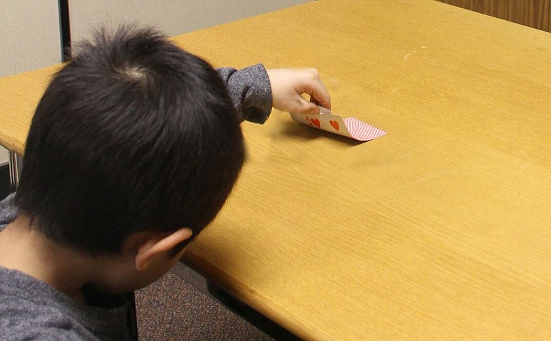 
              In this  Jan. 27, 2016 photo provided by the University of Toronto, a child peeks at a hidden card when an adult leaves the room and later lies about not peeking in research about how young children start to lie by Kang Lee at the University of Toronto in Toronto. Scientists say we all lie, and this year, politicians are bending the truth big time, with real consequences. By studying how and why we deceive, the experts say they can help us better understand the 2016 election season. (Paul Zheng/University of Toronto via AP)
            