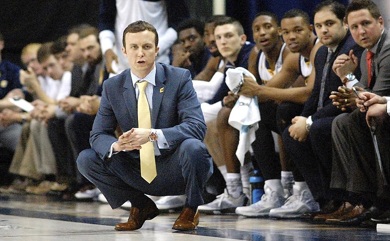 UTC head coach Matt McCall and the Mocs bench follow the action in a game against the Western Carolina Catamounts at McKenzie Area.